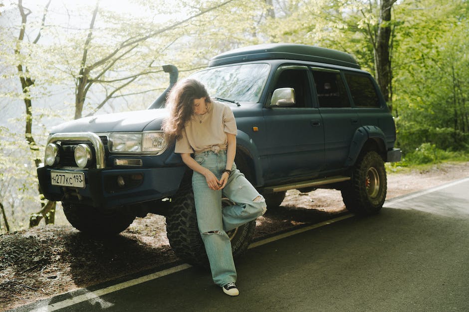 A woman maintaining a mini SUV