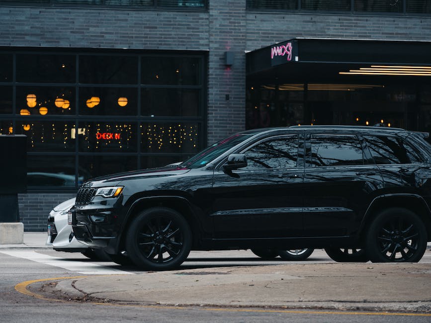 A woman driving a compact SUV on a city street.