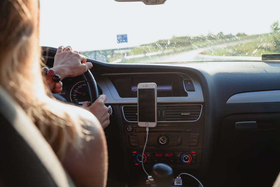 A woman driving a mini SUV, illustrating the safety features and technologies mentioned in the text.